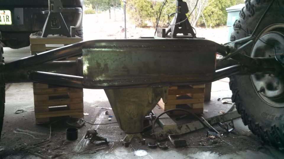 Rear axle assembly of a truck, supported by wooden blocks and jack stands