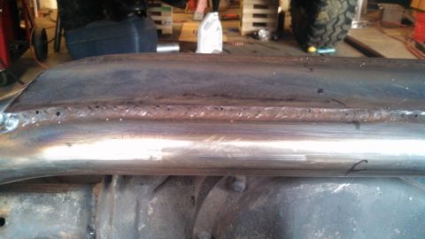 1967 Ford F-250 - Welded metal tubing is attached to the frame of a vehicle, likely undergoing modification or repair.