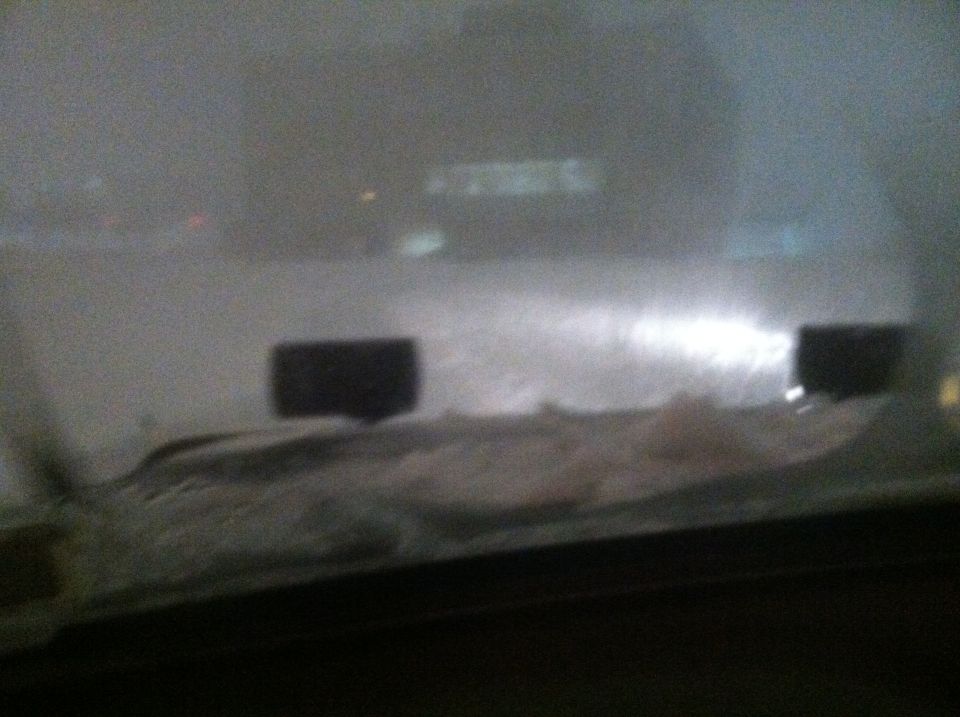 Interior view of dashboard with two dark rectangular objects and hazy background