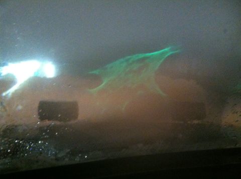 1989 Ford Bronco - Abstract glowing green shape with bright light, possibly a reflection or light effect.