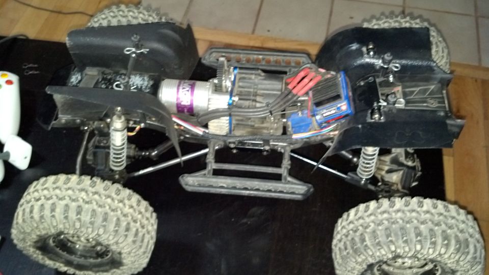 Remote control monster truck with exposed electronics and large tires