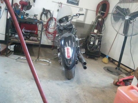 1995 Ford F-150 - This motorcycle is parked in a garage with various tools and equipment visible in the background.