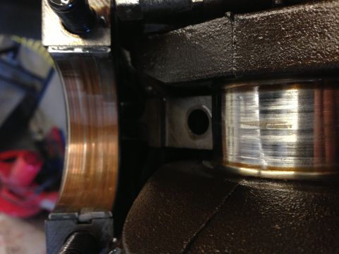 1966 Ford Bronco - This image shows a close-up view of an engine's crankshaft bearing, revealing signs of wear.