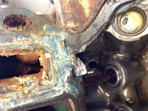 1966 Ford Bronco - Close-up of a severely rusted and damaged engine part, showing internal components and signs of wear.