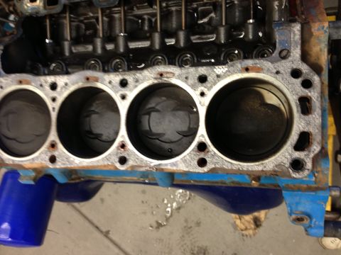 1966 Ford Bronco - Close-up view of an engine block's cylinders and pistons, with the valve train assembly visible.