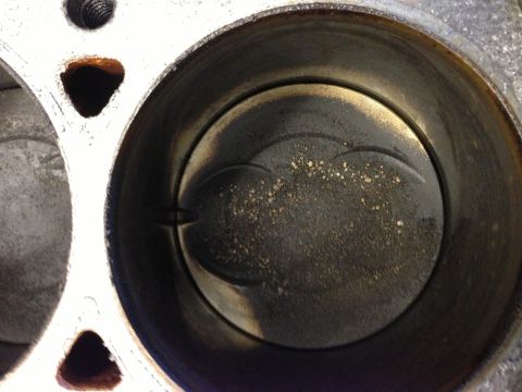 1966 Ford Bronco - Close-up view of an engine cylinder and piston, revealing internal wear and deposits.