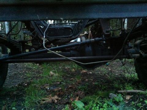 1994 Ford Bronco - Close-up view of the undercarriage, focusing on the suspension and rear differential components.