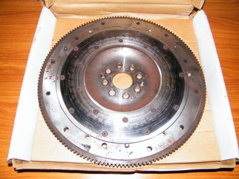 2004 Ford Crown Victoria - This is a car flywheel, a crucial component for manual transmissions, shown here in a cardboard box.