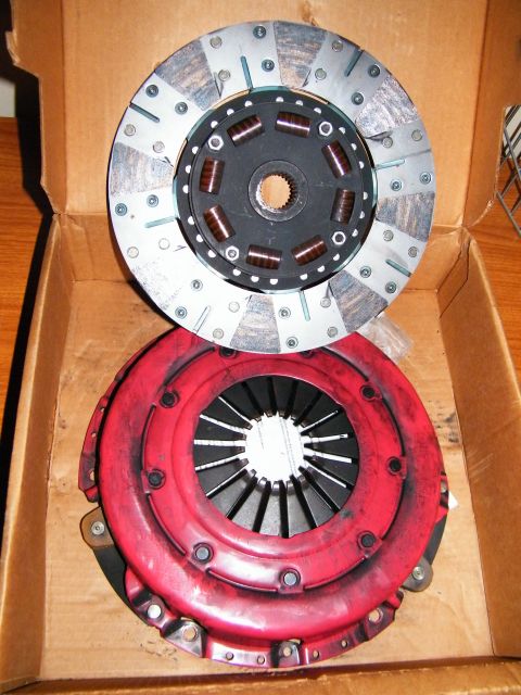 2004 Ford Crown Victoria - A clutch disc and pressure plate are shown inside a cardboard box.