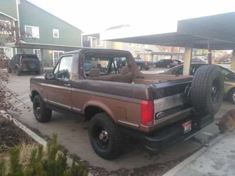 1992 Ford Bronco - This 1992 Ford Bronco is parked in a lot with other vehicles visible.