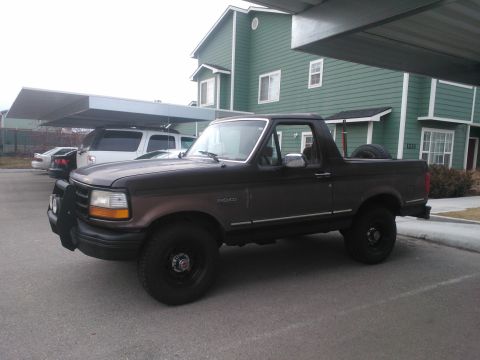 1992 Ford Bronco - This 1992 Ford Bronco is parked outdoors, with a spare tire mounted in the rear cargo area.