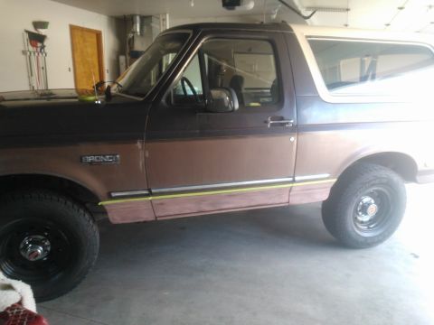 1992 Ford Bronco - Side view of a 1992 Ford Bronco, its distinctive body style and trim details.
