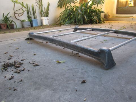1990 Ford Bronco - Roof rack assembly on concrete, with potted plants and cacti visible in the background.