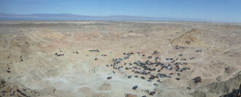 1997 Ford Ranger - A large group of vehicles gathered in a vast desert terrain under a clear blue sky.