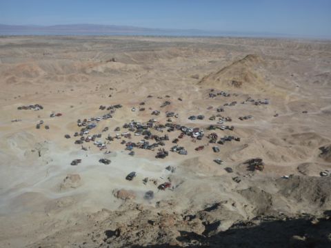 1997 Ford Ranger - A large gathering of off-road vehicles is spread across a vast desert terrain.