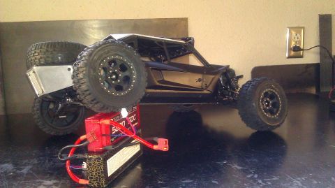 1996 Ford Bronco - RC rock crawler with attached batteries and a spare tire mounted on the rear.