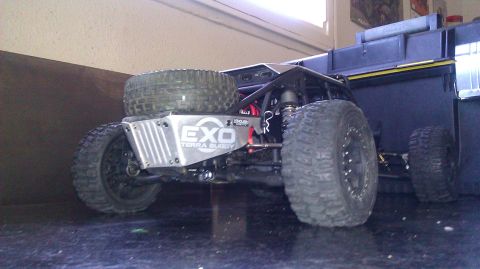 1996 Ford Bronco - Remote control buggy with large off-road tires and exposed roll cage sits on a dark surface.