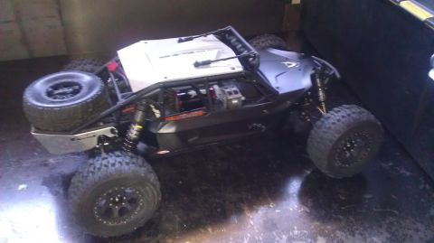 1996 Ford Bronco - This remote control rock crawler features a roll cage and large off-road tires, shown from a 3/4 front angle.