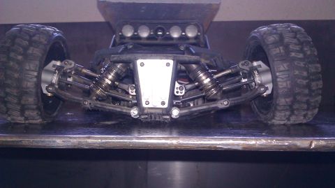1996 Ford Bronco - Close-up view of the front suspension and large tires on a remote-controlled vehicle.