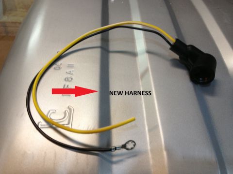 1978 Ford Bronco - A new wiring harness is shown with part markings and a red arrow pointing to it.