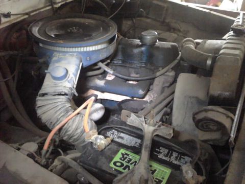 1979 Ford Bronco - Close-up view of a vehicle's engine bay, showing the air cleaner, battery, and radiator components.