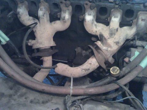 1979 Ford Bronco - Close-up view of the engine's exhaust manifolds and associated piping.