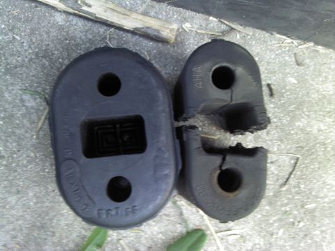2000 Lincoln Continental - A comparison of a good and a broken rubber exhaust hanger is shown.