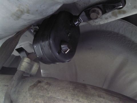 2000 Lincoln Continental - Close-up view of an exhaust hanger bracket on the underside of a vehicle.