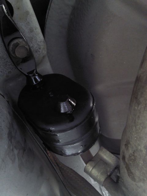 2000 Lincoln Continental - Underside view of a vehicle's exhaust hanger bracket, likely a suspension component.