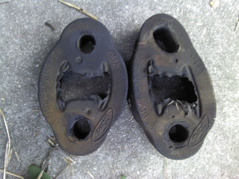 Two Ford exhaust hangers with part numbers F50C-5F282-BA and F50C-5F282-CA