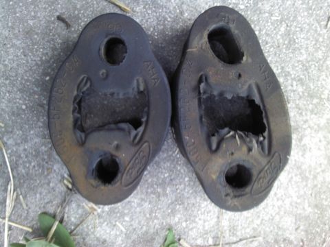 2000 Lincoln Continental - These rubber exhaust hangers show significant wear and tear, indicating a need for replacement.