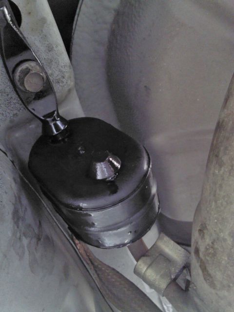 2000 Lincoln Continental - Underside view of a vehicle's exhaust hanger bracket, likely for suspension or exhaust system support.