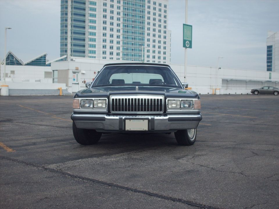 Front view of a 1991 Mercury Grand Marquis with a chrome grille