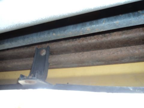 2004 Mercury Grand Marquis - The underside of the vehicle shows some rust on the frame components and a yellow painted body panel.