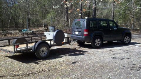 2011 Jeep Liberty - A dark 2011 Jeep Liberty is shown from the 3/4 front view, towing a trailer.