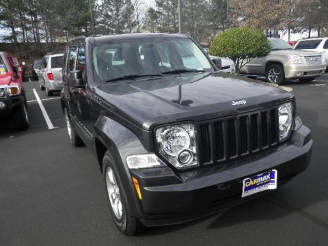 2011 Jeep Liberty - Front view of a 2011 Jeep Liberty parked in a lot with other vehicles.