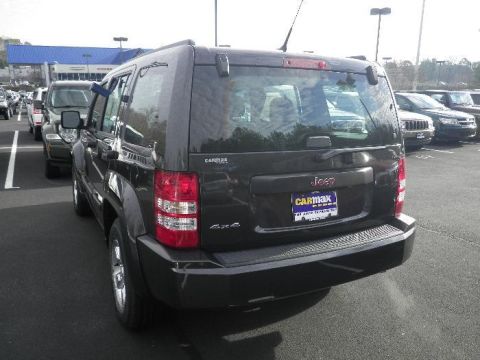 2011 Jeep Liberty - Rear view of a dark gray 2011 Jeep Liberty SUV parked in a car lot.