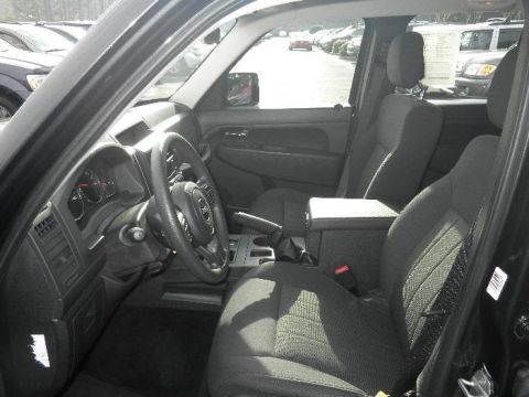 2011 Jeep Liberty - The interior of a Jeep Liberty is shown from the driver's perspective, looking towards the passenger side.