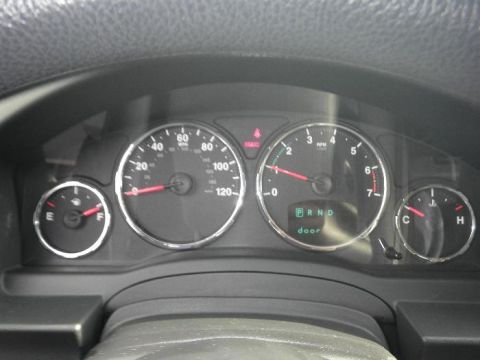 2011 Jeep Liberty - Dashboard gauges of a 2011 Jeep Liberty, showing speed, RPM, fuel, and temperature.