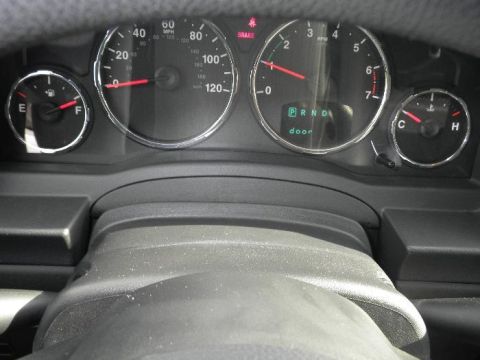 2011 Jeep Liberty - Interior view of a vehicle's dashboard gauges, including the speedometer and tachometer.