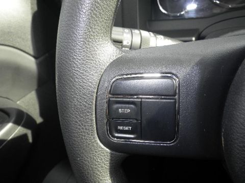 2011 Jeep Liberty - Interior view of a steering wheel, showing cruise control buttons. The registry claims this is a 2011 Jeep Liberty, but the image does not…