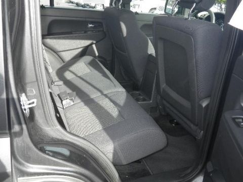 2011 Jeep Liberty - Interior view of the rear seating area of a vehicle, showing the seats and door panel.