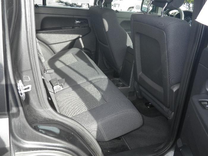Dark fabric rear seats and door panel of an SUV, with a watermark at the bottom right