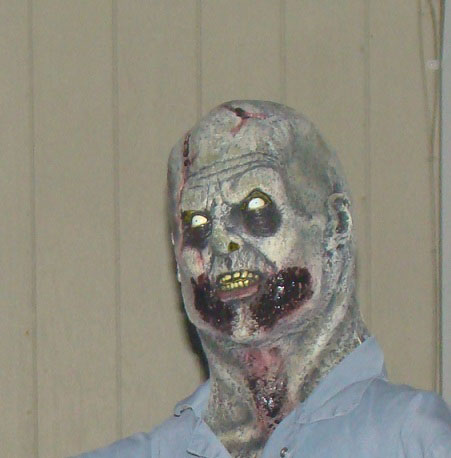 1989 Ford Bronco - A frightening zombie mask with a gruesome appearance, likely used as a Halloween decoration.