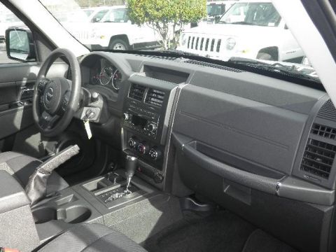 2011 Jeep Liberty - Interior view of a 2011 Jeep Liberty, with other vehicles visible outside.