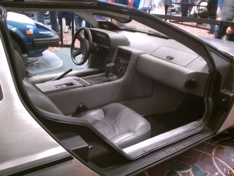 1998 Toyota Camry - The distinctive interior of a DeLorean DMC-12 is shown, with a glimpse of another vehicle outside.