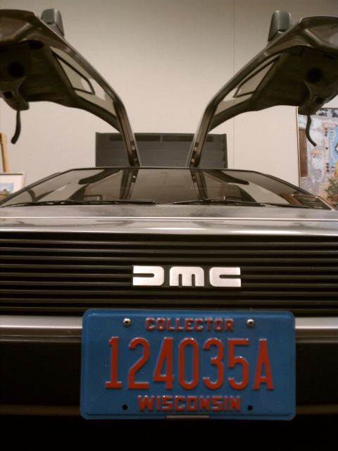 1998 Toyota Camry - This DMC car is shown from the front with its iconic gullwing doors open, revealing the DMC badge on the grille.