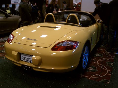 1998 Toyota Camry - A yellow convertible sports car is displayed indoors on a patterned carpet.