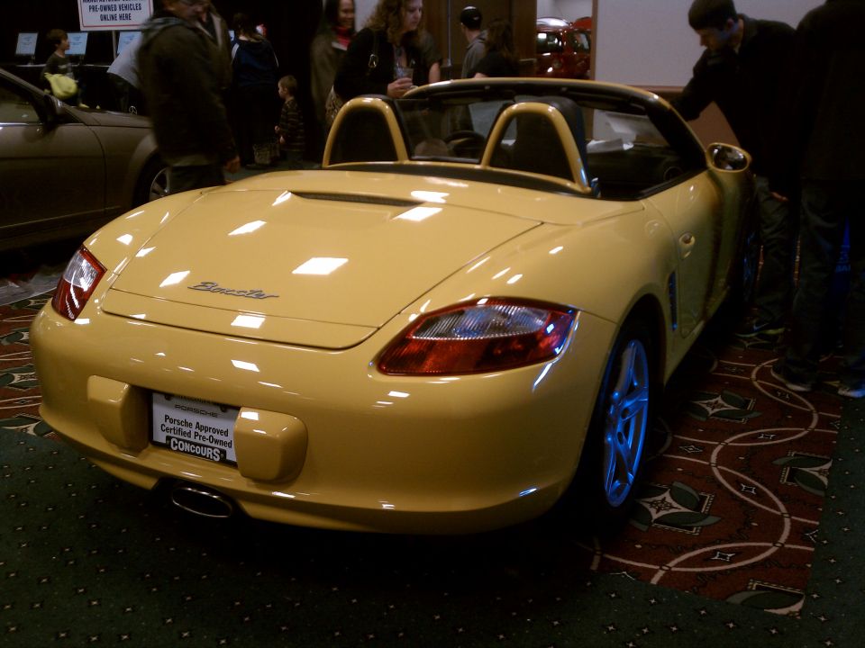 yellow convertible sports car with roll bars, rear view
