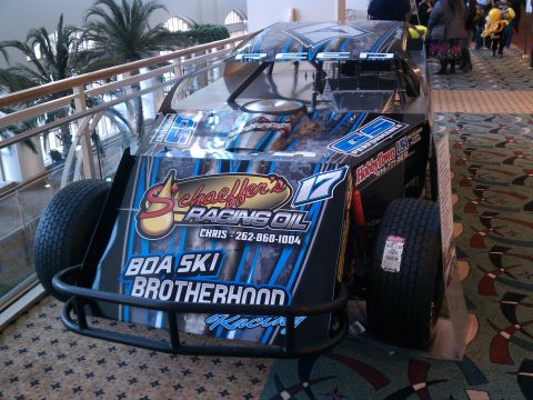 1998 Toyota Camry - A modified race car with sponsor decals is displayed indoors.